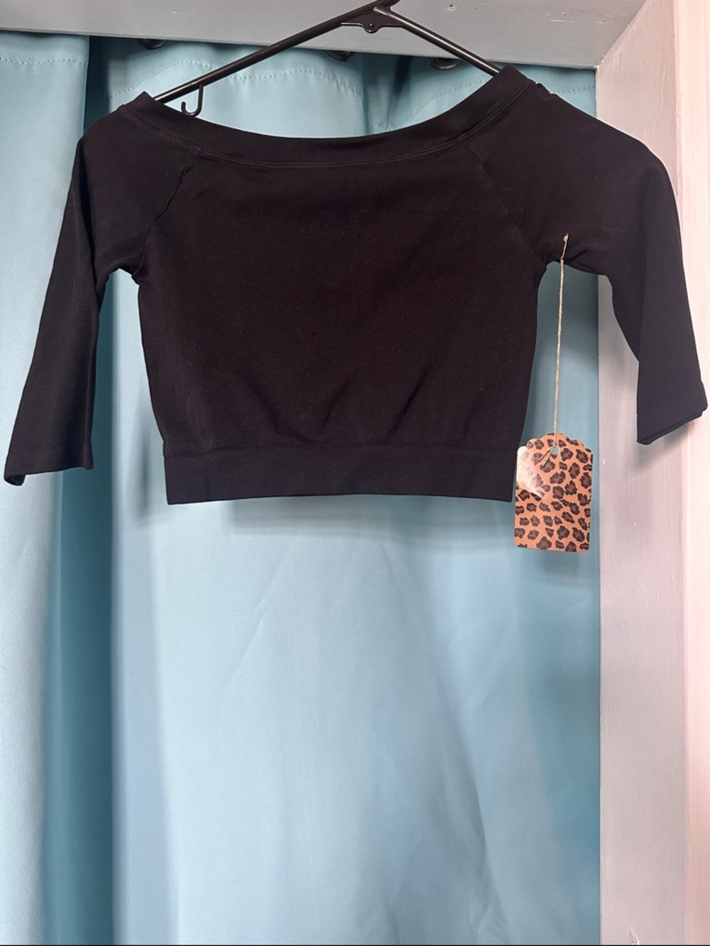 Enz’s Black Off-Shoulder Crop Top with Three-Quarter Sleeves